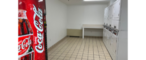 a kitchen with a refrigerator and a washer and dryer