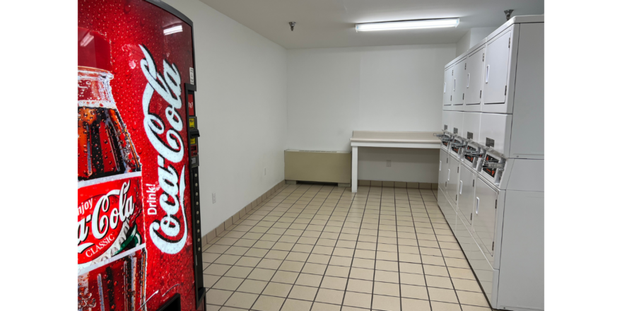 a kitchen with a refrigerator and a washer and dryer