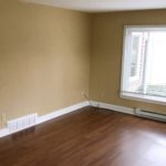 Living room with laminate, hardwood-style form and large picture window