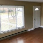 Living room with laminate, hardwood-style form, large picture window and fire place