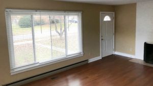 Living room with laminate, hardwood-style form, large picture window and fire place