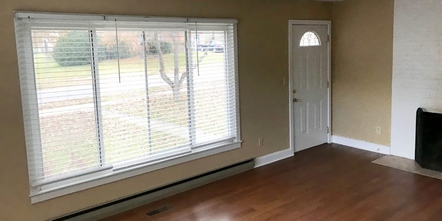 Living room with laminate, hardwood-style form, large picture window and fire place