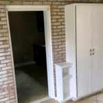 Tiled mudroom with storage cabinet