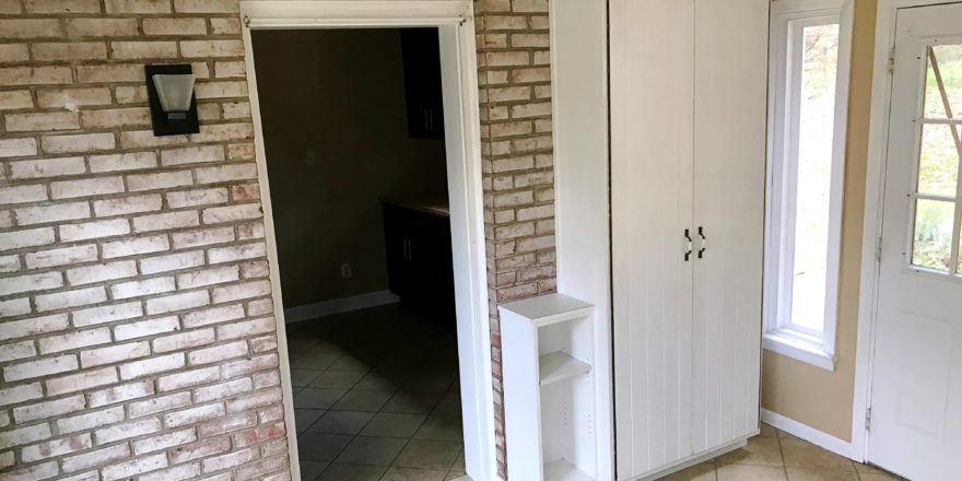 Tiled mudroom with storage cabinet