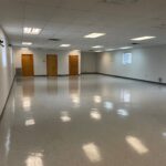 an empty room with several doors and windows
