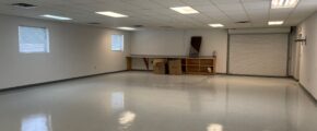 an empty room with white walls and floors