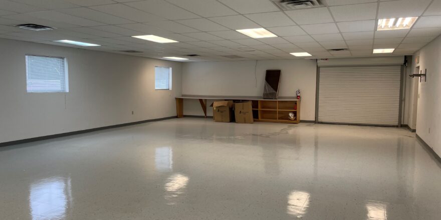 an empty room with white walls and floors