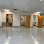 an empty room with three open doors