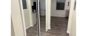 an empty room with a large mirror in it