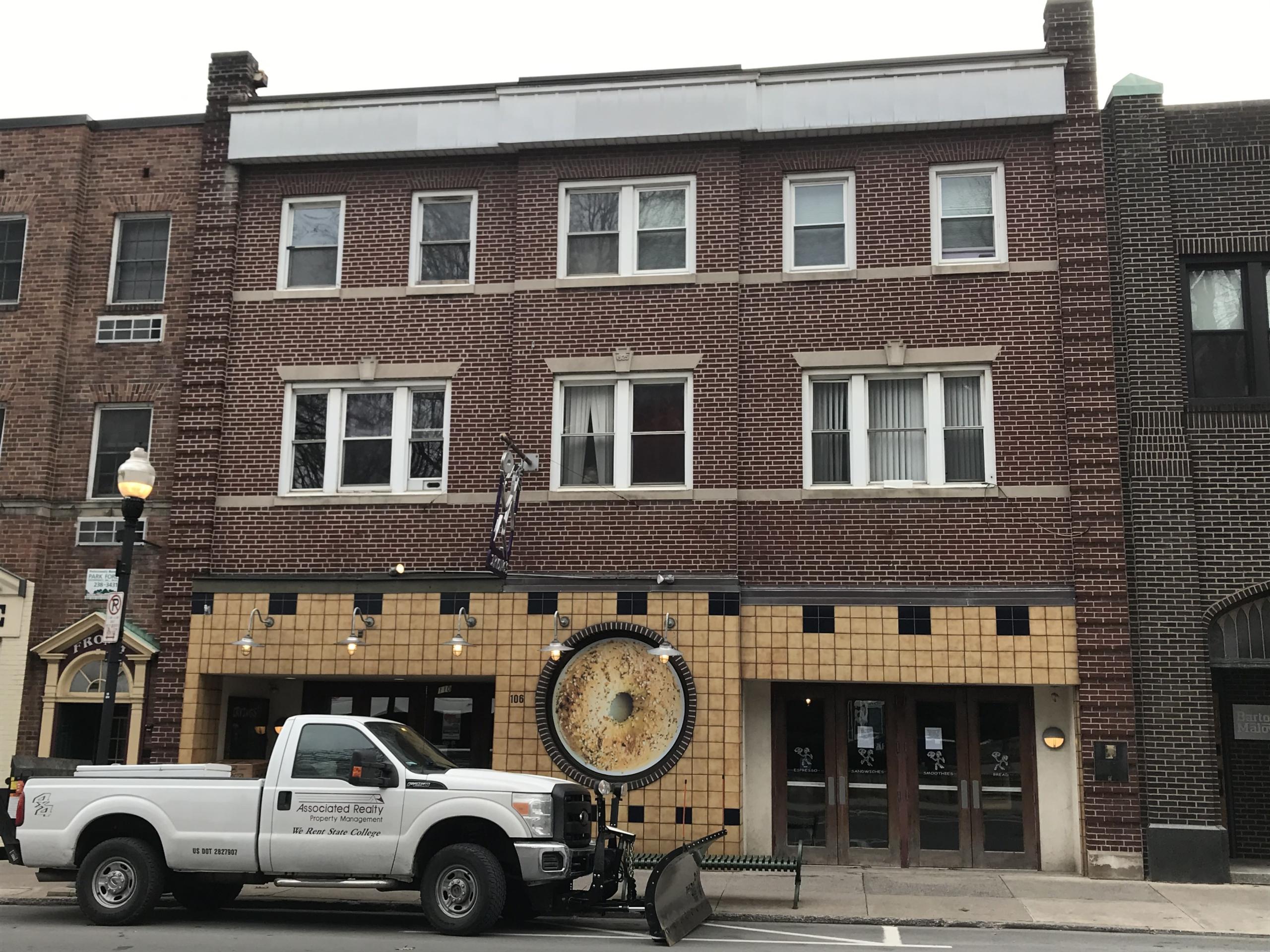 Campus view exterior, brick building with white pick up parked in front