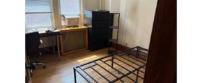 a bedroom with a bed, desk, and computer