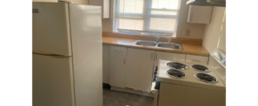a kitchen with a refrigerator, stove and sink