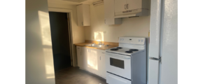 a kitchen with a refrigerator and a stove