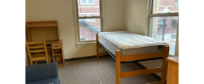 a room with a bed and a chair in it