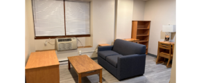 a living room filled with furniture and a window
