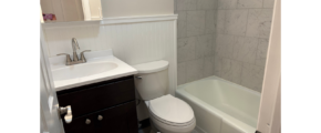 a bathroom with a toilet, sink, and bathtub