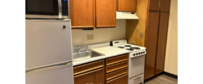 a kitchen with a microwave, stove, and refrigerator