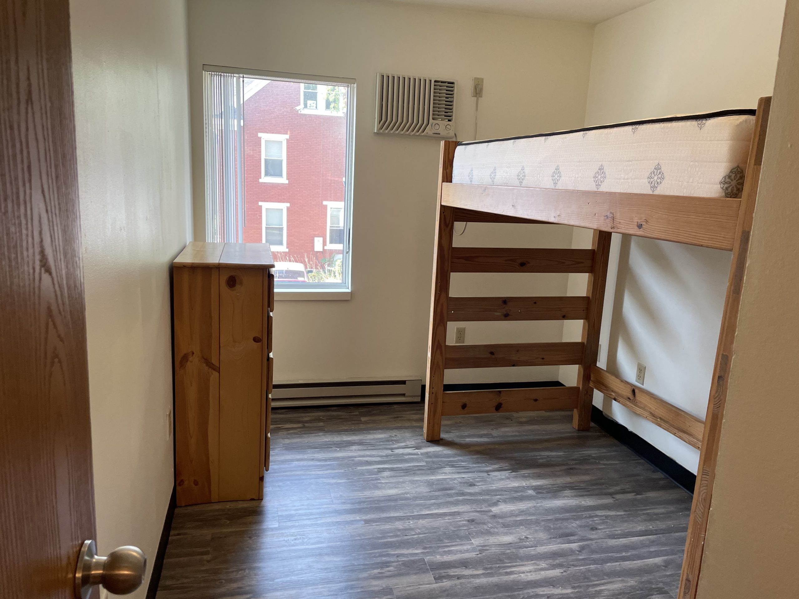 Loft bed and dresser in townhouse bedroom