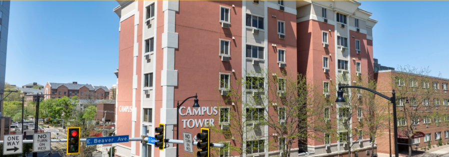 a red brick apartment building with a sign that says apply now for 2020 - 2021
