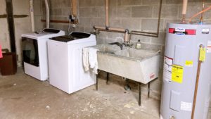 Laundry area with washer, dryer, and double sink laundry tub