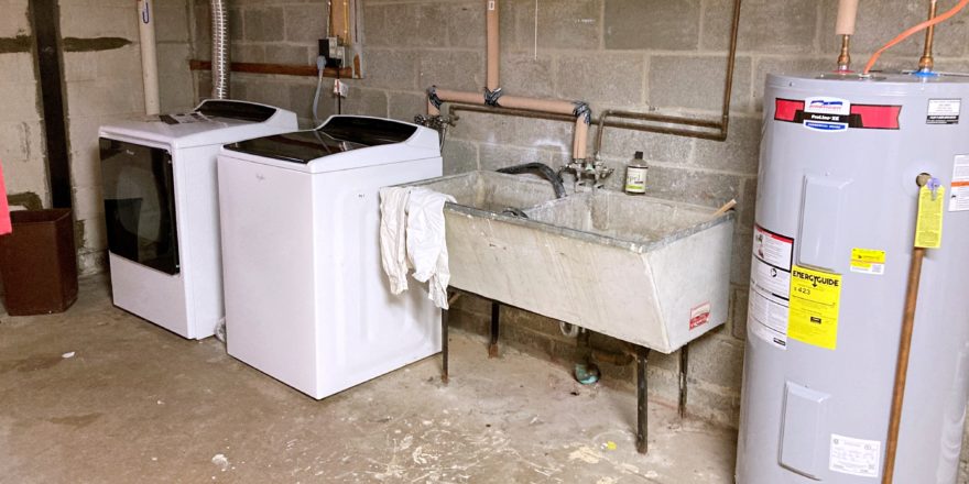 Laundry area with washer, dryer, and double sink laundry tub