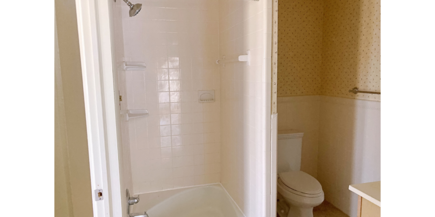 Bathroom with shower stall and toilet