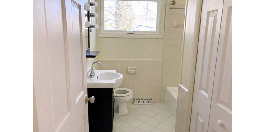 Bathroom with vanity, toilet, and tub/shower combo