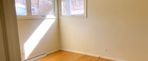 Unfurnished bedroom with wood floors and ceiling fan