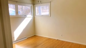 Unfurnished bedroom with wood floors and ceiling fan
