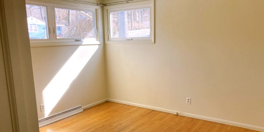 Unfurnished bedroom with wood floors and ceiling fan