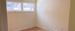 Unfurnished bedroom with wood floors and ceiling fan