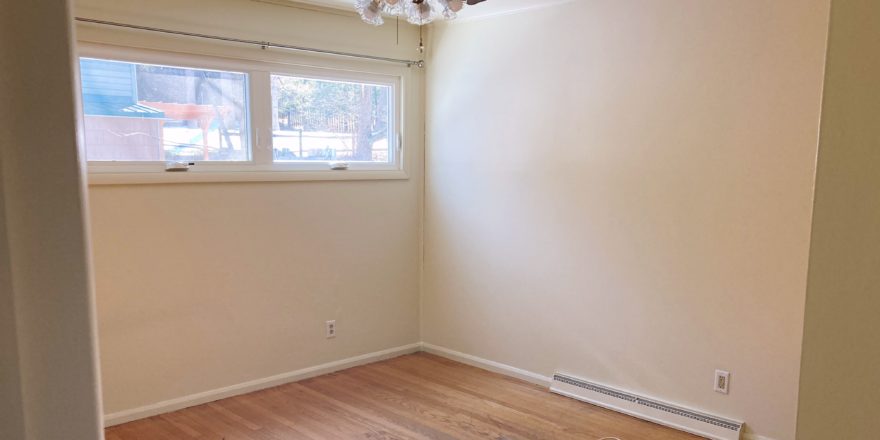 Unfurnished bedroom with wood floors and ceiling fan