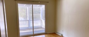 Unfurnished bedroom with wood floors, ceiling fan, and sliding glass door onto balcony