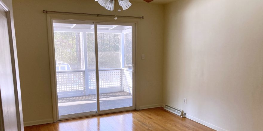 Unfurnished bedroom with wood floors, ceiling fan, and sliding glass door onto balcony