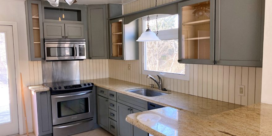 Kitchen with since, ceiling fan, cabinets, and stainless steel appliances