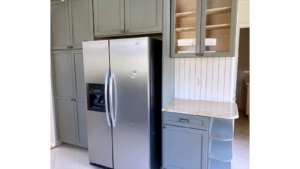 Kitchen with cabinets and stainless steel fridge