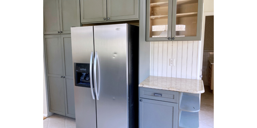 Kitchen with cabinets and stainless steel fridge