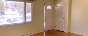 Unfurnished living room with wood floors and ceiling lighting fixture