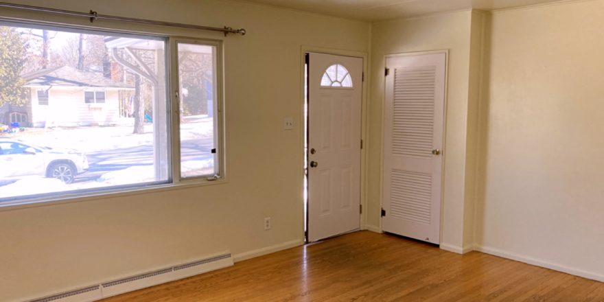 Unfurnished living room with wood floors and ceiling lighting fixture