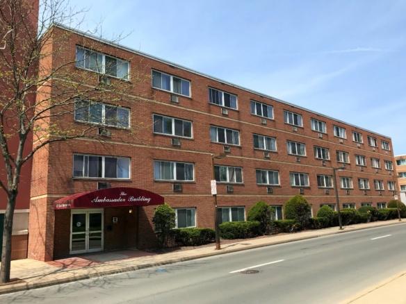 Brick building on beaver avenue with a maroon overhang over the entry door that says "ambassador building"