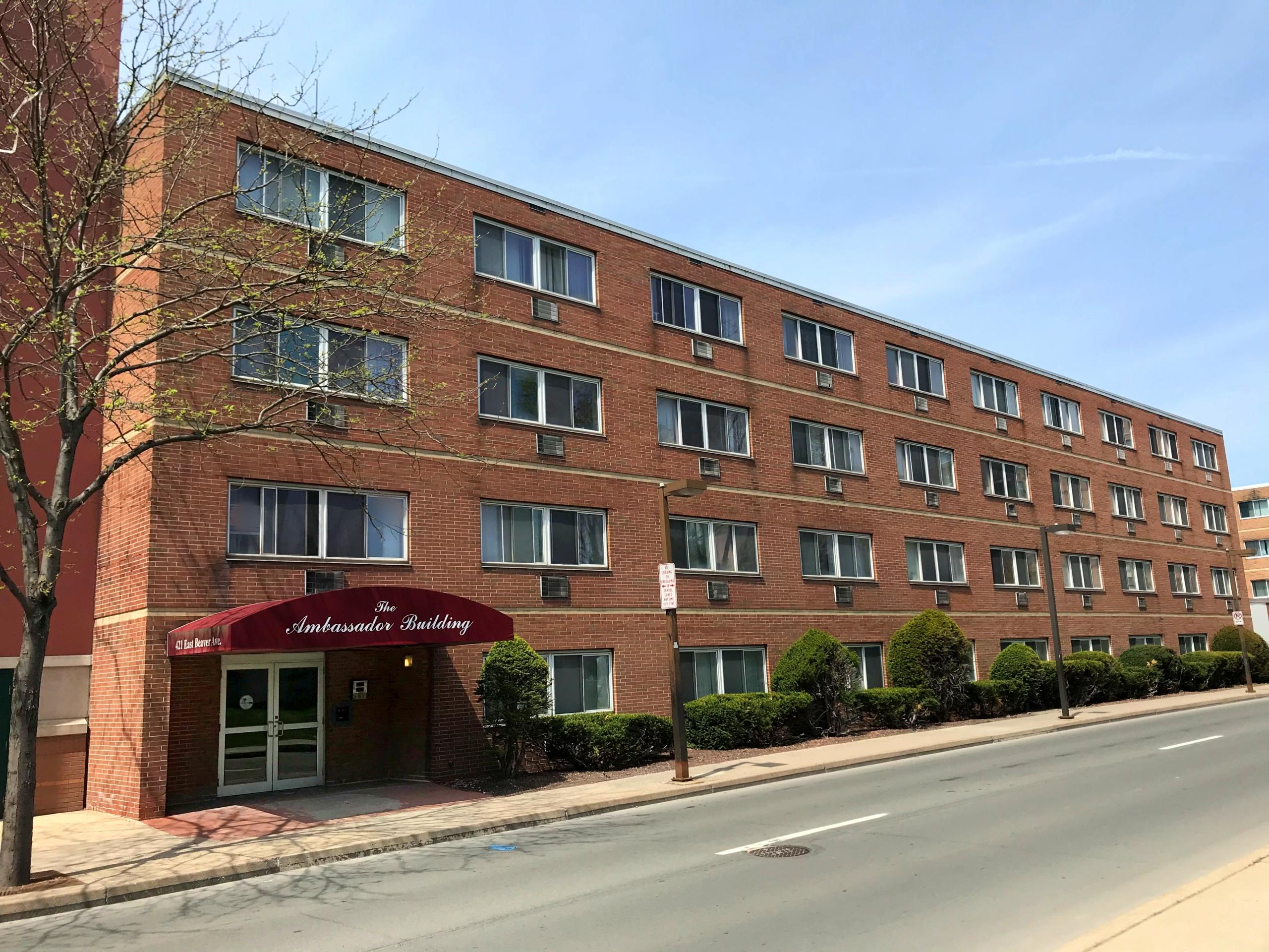 Brick building on beaver avenue with a maroon overhang over the entry door that says "ambassador building"