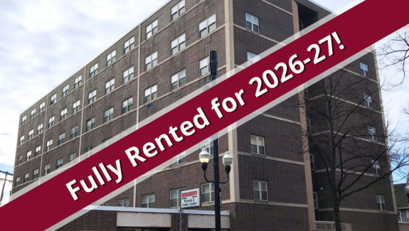 a building with a red ribbon over it that says fully rented for 205 - 207