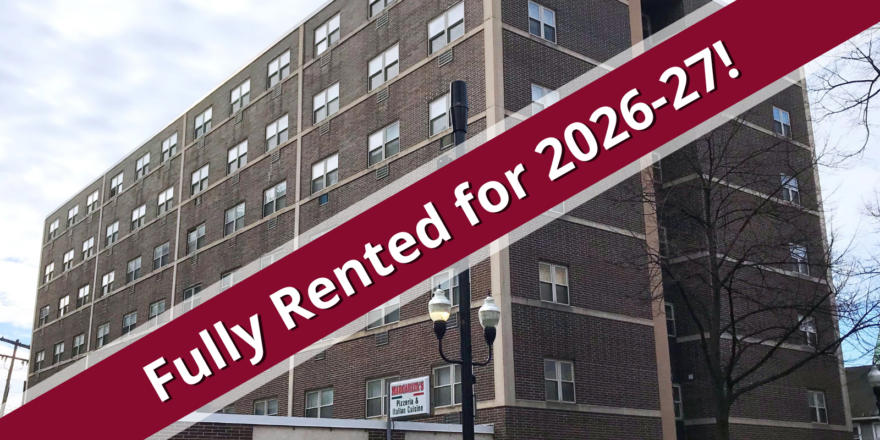 a building with a red ribbon over it that says fully rented for 205 - 207