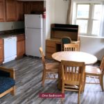 Living Room and Kitchen with wooden furniture, white appliances, and wood-tone cabinets