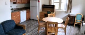 Living Room and Kitchen with wooden furniture, white appliances, and wood-tone cabinets