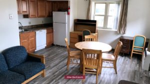 Living Room and Kitchen with wooden furniture, white appliances, and wood-tone cabinets