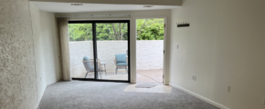 an empty room with sliding glass doors leading to a patio