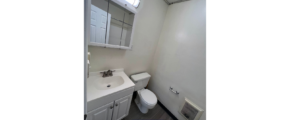 a bathroom with a sink, toilet and medicine cabinet