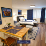 a room with a table, chairs, LVP, and pictures on the wall