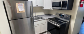 a kitchen with stainless steel appliances and white cabinets